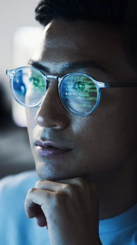 Man with computer screen development reflection in glasses