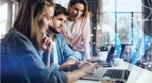 People in a meeting looking over the laptop, tech connection and network overlays