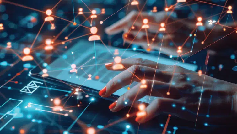 A woman's hands hovering over a digital tablet with images of social media avatars mapped and connected to each other presented as an overlay.