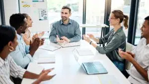 A team of male and female ethnically diverse business professionals discussing goals.