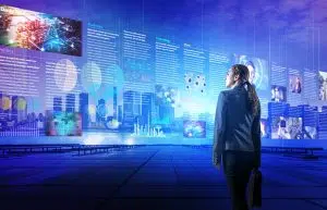Young woman in business attire viewing an electronic newspaper on futuristic looking computer screens hovering in the air.