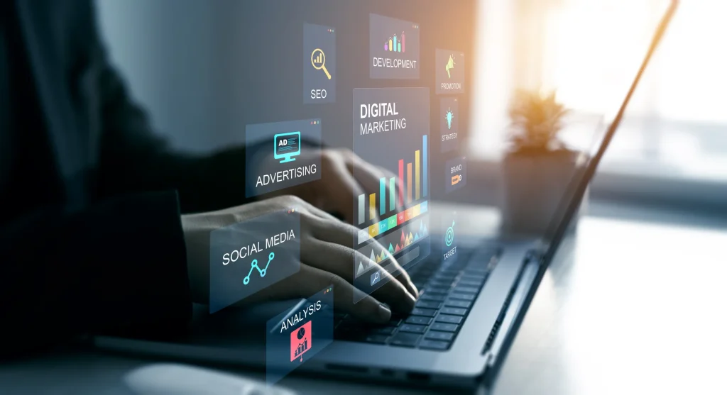 Hands using a laptop with overlaid digital marketing graphics for SEO, advertising, social media and analytics.
